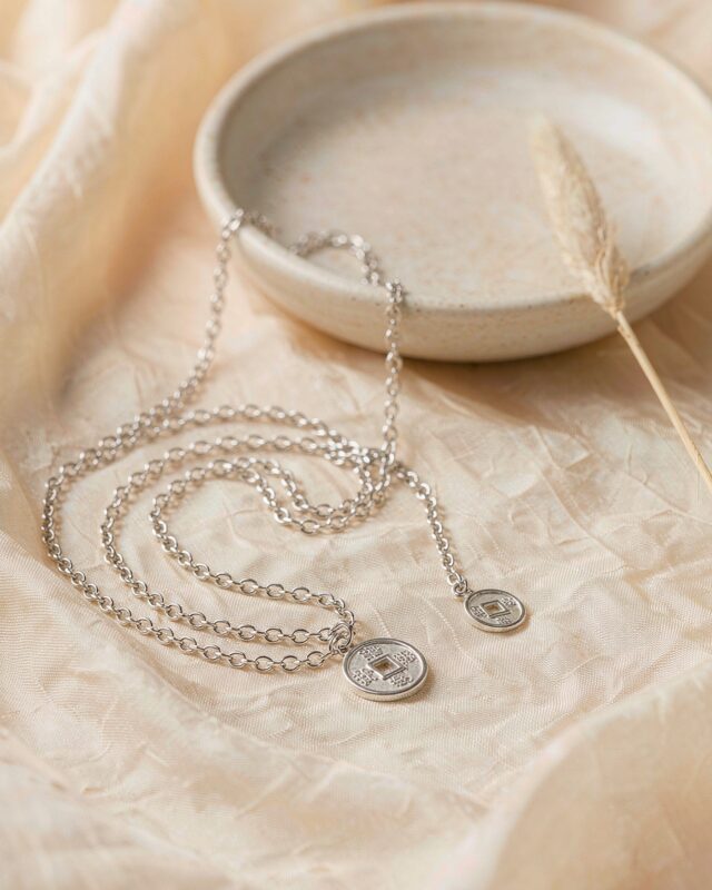 Silver Chinese coin pendant necklace with a square-hole coin on cream silk