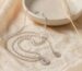 Silver Chinese coin pendant necklace with a square-hole coin on cream silk